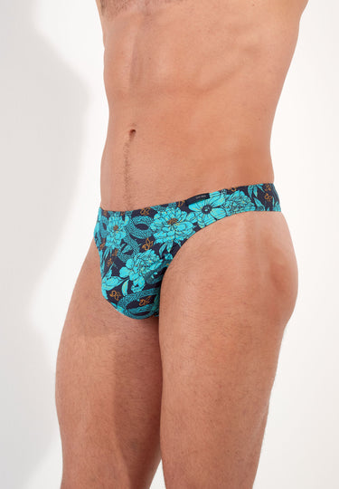 Teal floral-patterned men's underwear on a male model with a white background